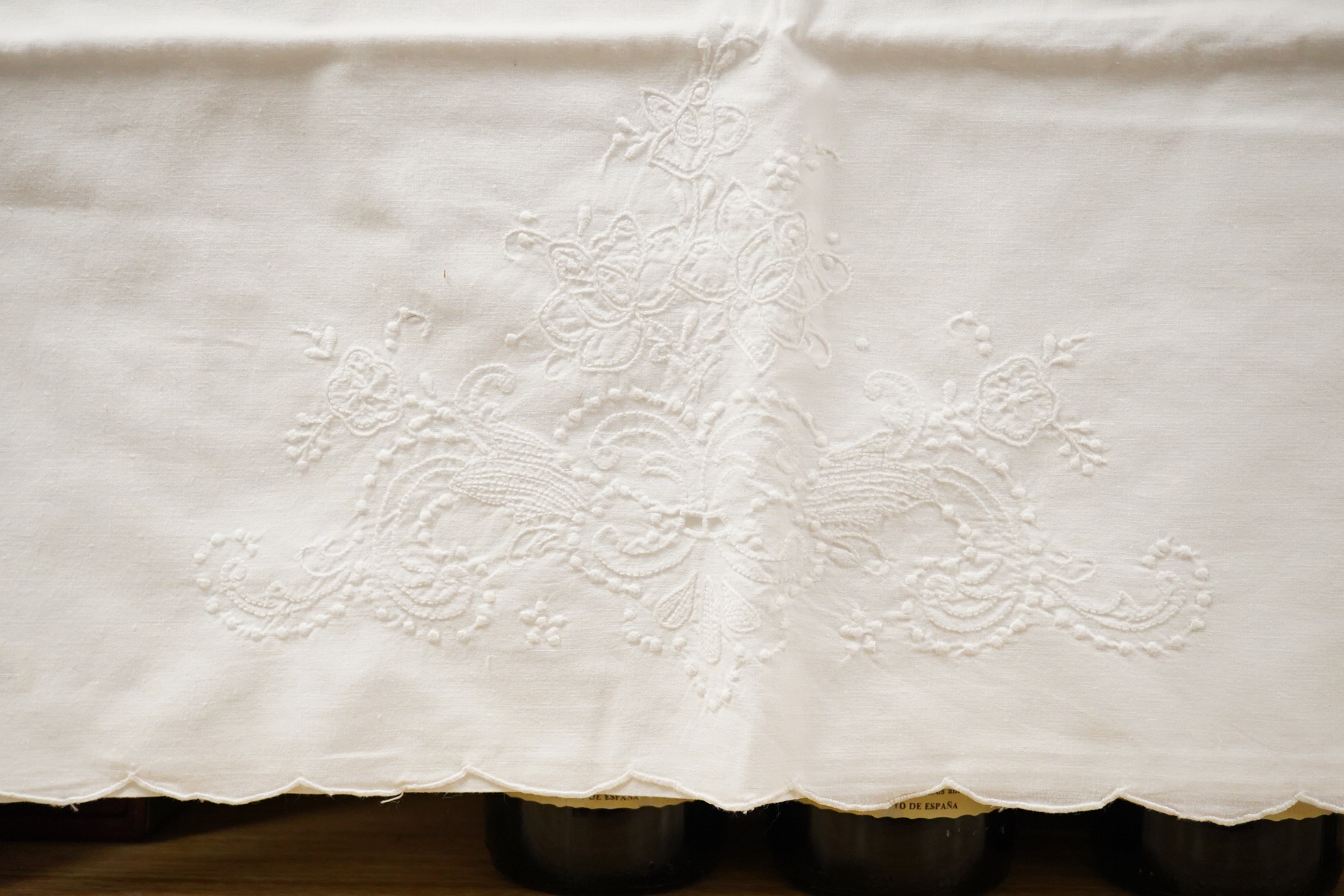 Two matching linen hand monogrammed sheets, one 216cm x 330cms, the other 212cm x 340 cms, together with three later monogrammed linen pillow cases and three embroidered cotton pillowcases.